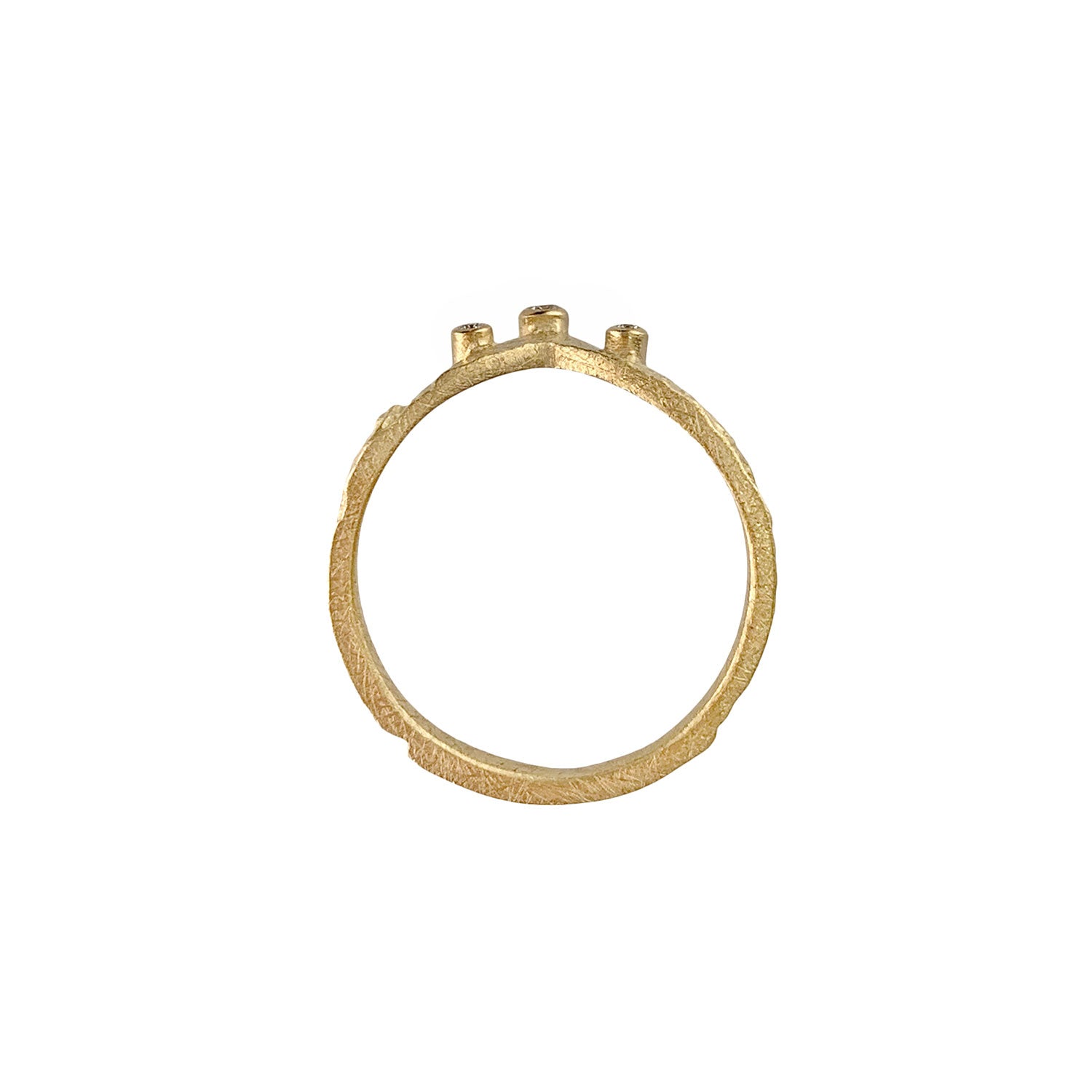 View of the ring as a circle. Pounded gold shows artisinal textural features. Gold wrapped sides on three diamonds are visible at the top of the circle.