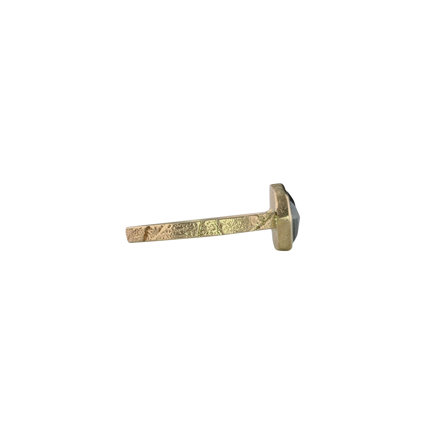 Side view of a ring with a narrow, textured gold band. On the right is the side of a gray speckled diamond.The diamond is encased in a smooth gold wrapping.