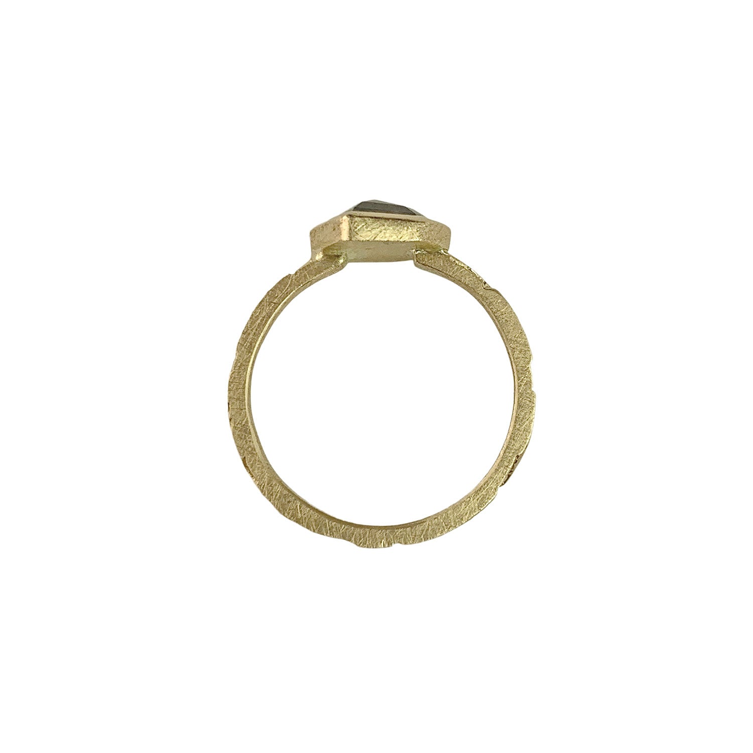 Vertical view of a ring with a narrow, textured gold band. At the top is the side of a gray speckled diamond.The diamond is encased in a smooth gold wrapping.