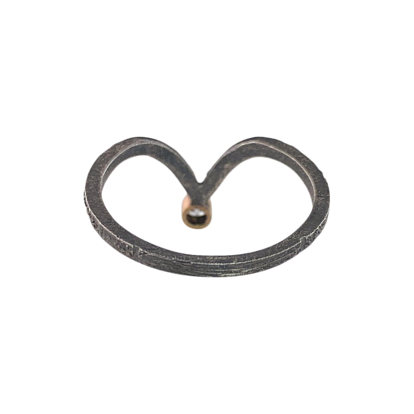 Back view of a textured dark gray band with a V shape on the far end. At the bottom of the V is smooth yellow gold, which holds a diamond (not visible).