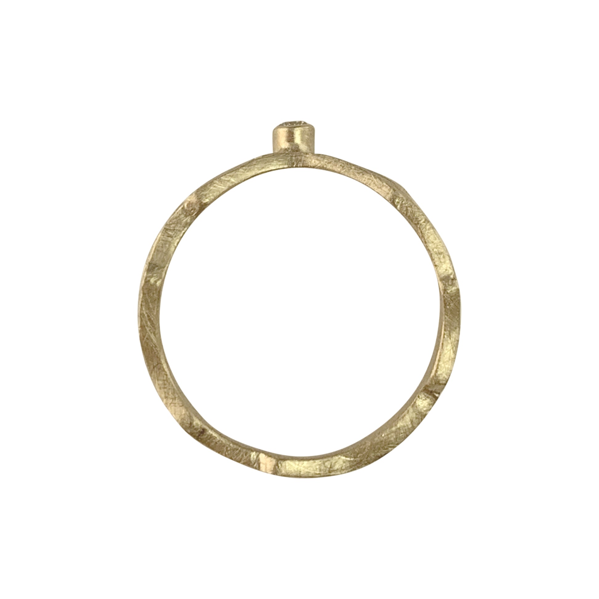 Vertical view of a gold ring with a wavy, textured band. On the top of the band is a gold setting that holds an almost flush diamond.
